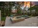 Stunning backyard pool and spa area with comfortable seating and a serene wooded backdrop at 127 Holt Ln, Mooresville, NC 28117