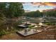 Scenic waterfront property featuring a fire pit, a seating area, and a boat dock for lakeside relaxation at 127 Holt Ln, Mooresville, NC 28117