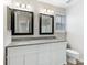 Bathroom featuring dual sinks with framed mirrors, granite countertop and modern vanity lighting at 12954 Sickles Dr, Charlotte, NC 28273