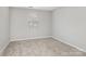 Neutral bedroom featuring a window and plush carpeting, perfect for relaxation at 12954 Sickles Dr, Charlotte, NC 28273