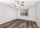 This spacious bedroom features wood-look floors and a ceiling fan at 12954 Sickles Dr, Charlotte, NC 28273