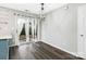 Dining area with laminate floors, sliding glass doors, and a contemporary light fixture at 12954 Sickles Dr, Charlotte, NC 28273