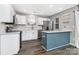 Modern kitchen featuring stainless steel appliances, white cabinets, and an island with bar seating at 12954 Sickles Dr, Charlotte, NC 28273