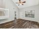 Bright and airy living room features laminate floors, a ceiling fan, and a view of the entry at 12954 Sickles Dr, Charlotte, NC 28273