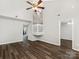 Open-concept living room features high ceilings, a fan, laminate floors, and views of the staircase at 12954 Sickles Dr, Charlotte, NC 28273