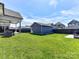 Grassy backyard featuring a detached garage, perfect for outdoor activities and storage at 13702 Jacks Ln, Pineville, NC 28134