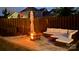 Inviting backyard patio with a cozy fire pit, comfortable seating, and ambient lighting at 13702 Jacks Ln, Pineville, NC 28134