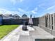 Relaxing backyard patio area with comfortable seating, a fire pit, and a fenced perimeter at 13702 Jacks Ln, Pineville, NC 28134