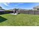 Spacious backyard featuring a well-maintained lawn and a patio area with a fire pit at 13702 Jacks Ln, Pineville, NC 28134