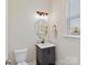 A half bath features a stylish vanity, modern fixtures, and a bright, clean aesthetic at 13702 Jacks Ln, Pineville, NC 28134