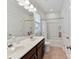 Neat bathroom showing double sinks, a bathtub with a shower, and ample lighting at 13702 Jacks Ln, Pineville, NC 28134