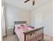 Charming bedroom featuring a ceiling fan and neutral carpet at 13702 Jacks Ln, Pineville, NC 28134