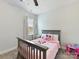 Warm bedroom featuring a ceiling fan, neutral carpet, and cozy bed at 13702 Jacks Ln, Pineville, NC 28134