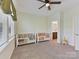 Bright bedroom showcasing the two beds, ceiling fan and neutral decor at 13702 Jacks Ln, Pineville, NC 28134