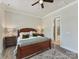 Comfortable bedroom with a ceiling fan, wood-look floors, and ensuite bathroom at 13702 Jacks Ln, Pineville, NC 28134