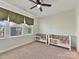 Cozy bedroom featuring two cribs, leaf-patterned wallpaper, and lots of natural light at 13702 Jacks Ln, Pineville, NC 28134