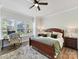 A bright bedroom features a bed, an office area, and lots of natural light at 13702 Jacks Ln, Pineville, NC 28134