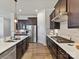 This kitchen boasts stainless steel appliances, ample countertop space, and stylish dark wood cabinetry at 13702 Jacks Ln, Pineville, NC 28134