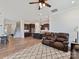 Open-concept living area showcasing hardwood floors, a spacious layout, and a view of the kitchen at 13702 Jacks Ln, Pineville, NC 28134