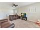 Cozy living room features plush seating, neutral walls, and a ceiling fan for added comfort at 13702 Jacks Ln, Pineville, NC 28134
