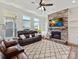 Cozy living room with a stone fireplace, plush seating, and plenty of natural light at 13702 Jacks Ln, Pineville, NC 28134