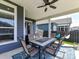 Covered patio with fan, features an outdoor dining area, creating an inviting space at 13702 Jacks Ln, Pineville, NC 28134