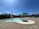 Community splash pad with spraying features and nearby pool house in a modern design at 13702 Jacks Ln, Pineville, NC 28134