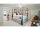 Comfortable bedroom featuring a four-poster bed, patterned wallpaper, and soft carpet, exuding a cozy ambiance at 13916 & 13912 Sledge Rd, Charlotte, NC 28278