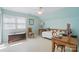 Bright bedroom featuring light blue walls, large windows, and a comfortable daybed, perfect for relaxation and work at 13916 & 13912 Sledge Rd, Charlotte, NC 28278