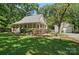 A charming home with a welcoming front porch and detached garage, nestled in a lush green setting at 13916 & 13912 Sledge Rd, Charlotte, NC 28278
