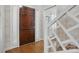Light-filled foyer showcasing a wooden front door, stylish wallpaper, and staircase with decorative railings at 13916 & 13912 Sledge Rd, Charlotte, NC 28278