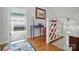 Cozy upstairs landing area with hardwood floors, soft lighting, and inviting seating with a glimpse of an adjoining room at 13916 & 13912 Sledge Rd, Charlotte, NC 28278