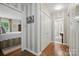 Inviting hallway with striped walls, closet, and doorway to bathroom and bedroom featuring classic design elements at 13916 & 13912 Sledge Rd, Charlotte, NC 28278
