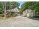 Charming home exterior featuring a covered porch, well-maintained landscaping, a detached garage, and ample parking space at 13916 & 13912 Sledge Rd, Charlotte, NC 28278