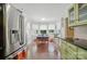 Cozy eat-in kitchen area with brick floors, abundant windows, and stainless steel refrigerator at 13916 & 13912 Sledge Rd, Charlotte, NC 28278