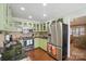 Quaint kitchen with stainless steel appliances, granite countertops, and light green cabinets at 13916 & 13912 Sledge Rd, Charlotte, NC 28278