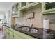 Close-up of a kitchen sink with granite countertops and tiled backsplash, and cabinetry at 13916 & 13912 Sledge Rd, Charlotte, NC 28278