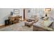 Comfortable living room featuring a work space, seating area, and area rug on hardwood floors at 13916 & 13912 Sledge Rd, Charlotte, NC 28278