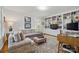 Cozy living room with built-in bookshelves, comfortable seating, and a warm, inviting atmosphere at 13916 & 13912 Sledge Rd, Charlotte, NC 28278