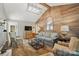 Comfortable living room featuring wood accent wall, vaulted ceilings, and ample seating at 13916 & 13912 Sledge Rd, Charlotte, NC 28278