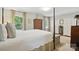 Bright main bedroom with four-poster bed, natural light, and spacious layout at 13916 & 13912 Sledge Rd, Charlotte, NC 28278