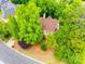 An aerial view shows the home and property surrounded by lush mature trees at 15618 Eagleview Dr, Charlotte, NC 28278