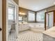 Full bathroom features double windows, double sinks, and walk-in shower at 15618 Eagleview Dr, Charlotte, NC 28278