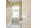 White bathroom with shower and window at 15618 Eagleview Dr, Charlotte, NC 28278