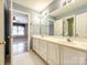 Bathroom with double sink and view to bedroom at 15618 Eagleview Dr, Charlotte, NC 28278