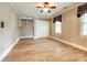 Bedroom with hardwood floors, built-in shelving and two large windows with coverings at 15618 Eagleview Dr, Charlotte, NC 28278