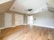 Bright bedroom with hardwood floors, a ceiling fan, and closet doors at 15618 Eagleview Dr, Charlotte, NC 28278