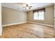 A bright bedroom with hardwood floors and one large window with a decorative covering at 15618 Eagleview Dr, Charlotte, NC 28278