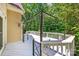 View of the spacious white deck with metal canopy, surrounded by lush greenery at 15618 Eagleview Dr, Charlotte, NC 28278