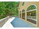 Spacious deck with white railing and metal canopy, accessed through large arched windows at 15618 Eagleview Dr, Charlotte, NC 28278